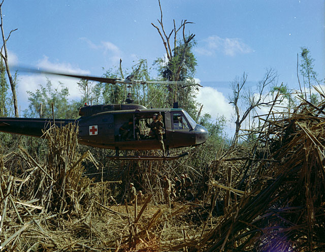 A UH-1 Huey makes a Dustoff to pick up an injured man who broke his leg jumping from a UH-1 during an insertion about 12 miles south of the DMZ. 